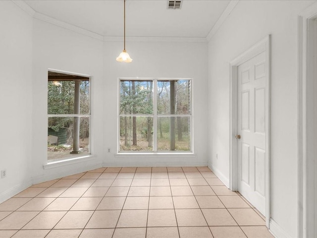 unfurnished dining area featuring light tile patterned floors, plenty of natural light, and ornamental molding