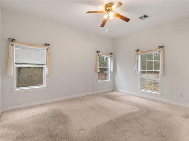 carpeted empty room featuring ceiling fan