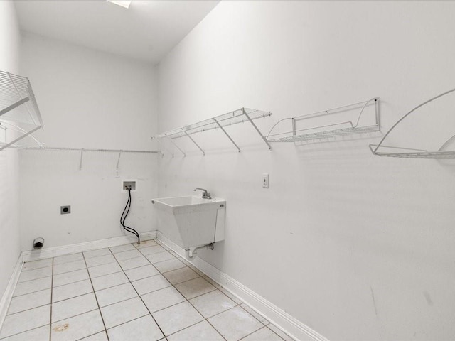 washroom with light tile patterned floors, sink, electric dryer hookup, and hookup for a washing machine