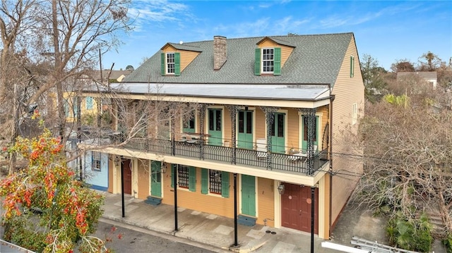 view of front of house with a garage and a balcony