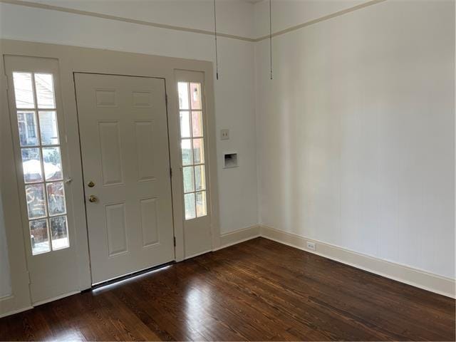 foyer featuring dark wood-style flooring and baseboards