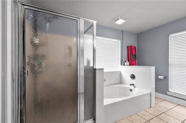 bathroom with shower with separate bathtub and tile patterned floors