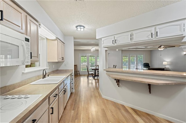 34633 W Dubuisson Rd, Slidell, LA 70460 - kitchen with white appliances, a sink, light wood finished floors, light countertops, and a textured ceiling