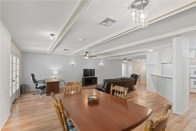 34633 W Dubuisson Rd, Slidell, LA 70460 - dining area with light wood finished floors, a textured ceiling, healthy amount of natural light, beam ceiling, and ceiling fan