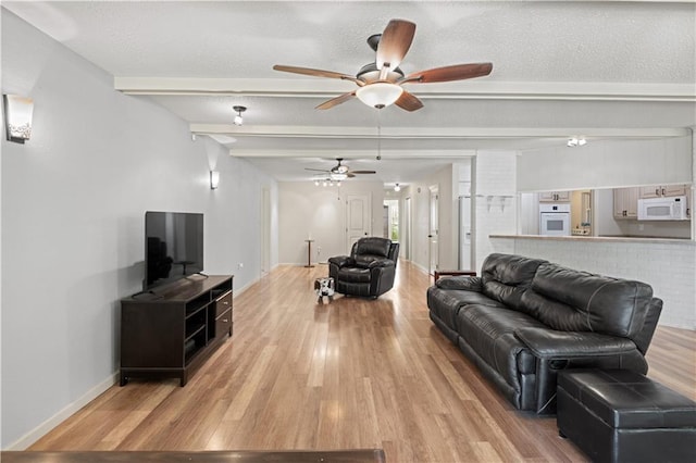 34633 W Dubuisson Rd, Slidell, LA 70460 - living area featuring wood finished floors, ceiling fan, beamed ceiling, and baseboards