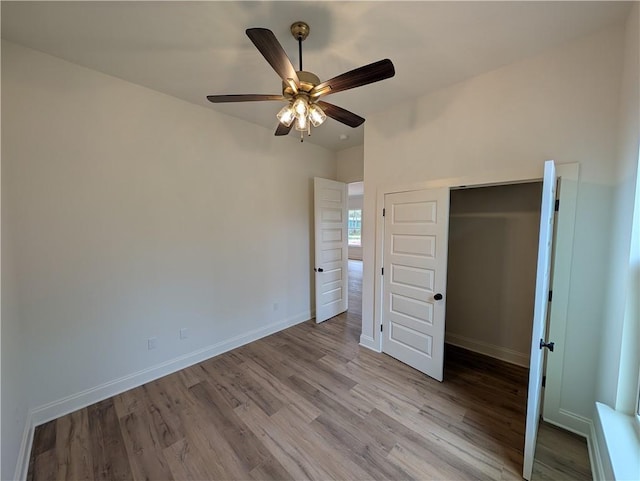 unfurnished bedroom with ceiling fan and light hardwood / wood-style flooring