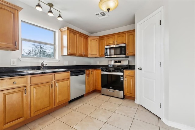 kitchen with sink, appliances with stainless steel finishes, and light tile patterned floors