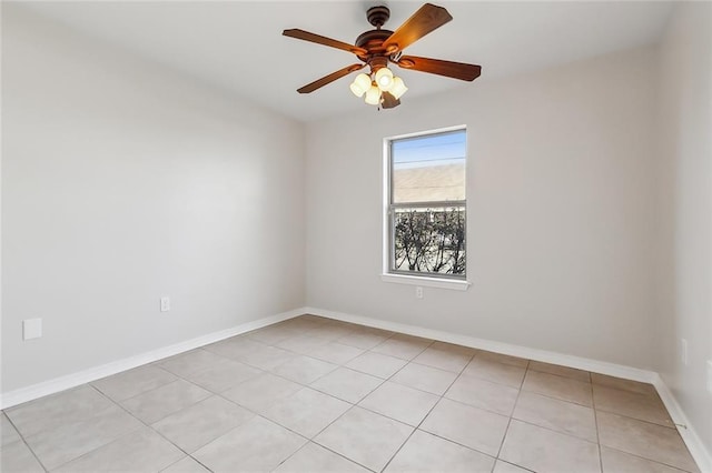 tiled spare room with ceiling fan