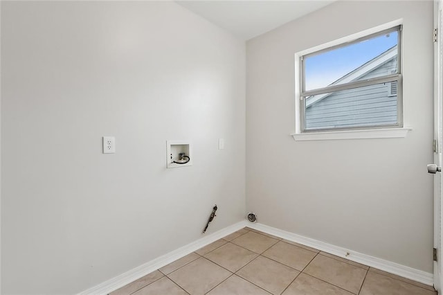 clothes washing area featuring light tile patterned floors and washer hookup