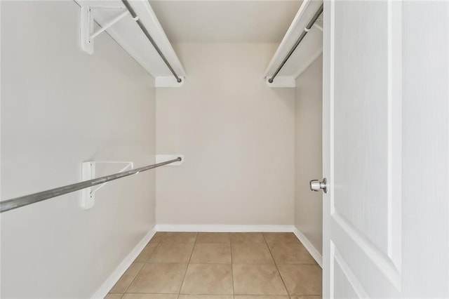 walk in closet featuring light tile patterned flooring