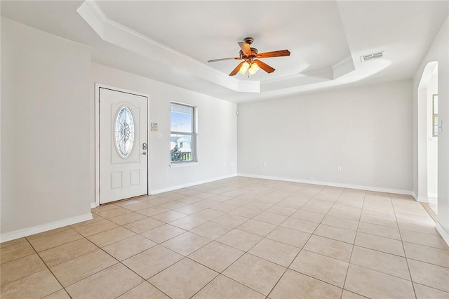 entrance foyer with ceiling fan, light tile patterned floors, crown molding, and a raised ceiling