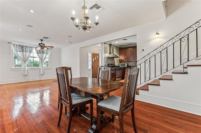 dining area with light wood finished floors, stairs, baseboards, and visible vents