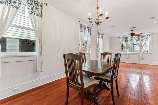 dining space featuring recessed lighting, ceiling fan with notable chandelier, baseboards, and wood finished floors