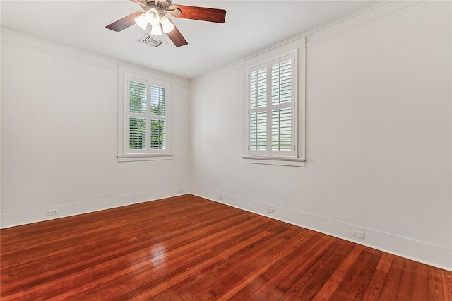 unfurnished room with baseboards, visible vents, ornamental molding, ceiling fan, and wood finished floors