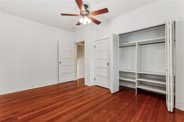 unfurnished bedroom with baseboards, crown molding, a ceiling fan, and dark wood-type flooring