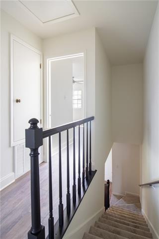 stairway with baseboards and wood finished floors