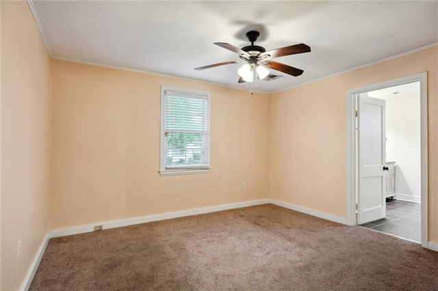 empty room featuring visible vents, baseboards, a ceiling fan, dark carpet, and crown molding