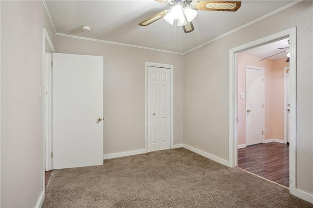 unfurnished bedroom featuring baseboards, carpet, ornamental molding, and a closet