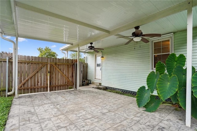 view of patio with a gate, ceiling fan, and fence