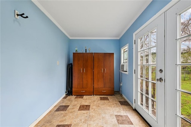 doorway to outside with ornamental molding, stone finish floor, cooling unit, and baseboards