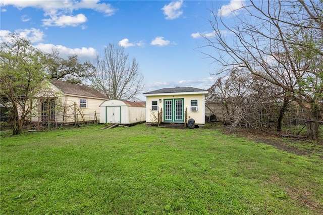 view of yard with a storage shed, fence, and an outdoor structure