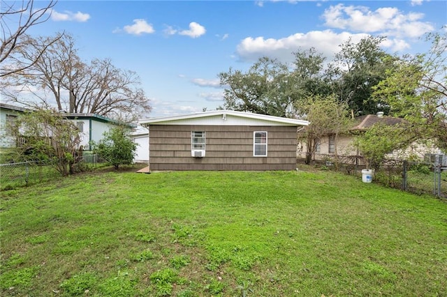 back of house featuring a fenced backyard and a yard