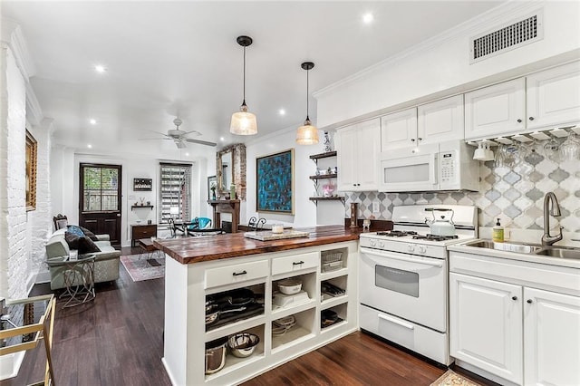 kitchen with white appliances, visible vents, wood counters, and white cabinetry