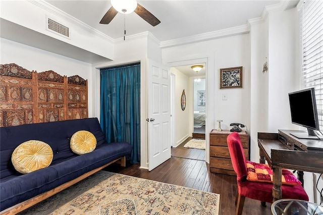 home office with baseboards, visible vents, a ceiling fan, dark wood-style floors, and ornamental molding