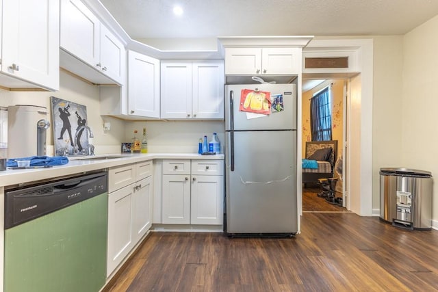 226062 N Roman St, New Orleans, LA 70117 - kitchen featuring white cabinets, light countertops, dishwashing machine, a sink, and freestanding refrigerator