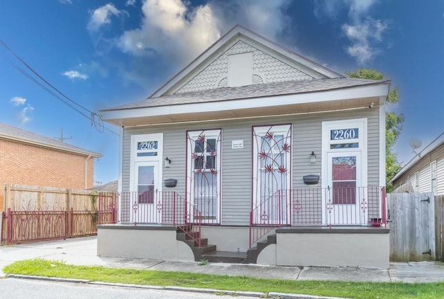 226062 N Roman St, New Orleans, LA 70117 - view of front of house featuring fence and a shingled roof
