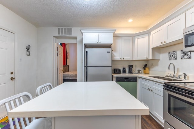 226062 N Roman St, New Orleans, LA 70117 - kitchen with a textured ceiling, visible vents, stainless steel appliances, and a sink