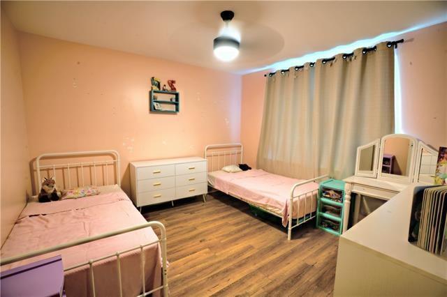 bedroom with a ceiling fan and wood finished floors