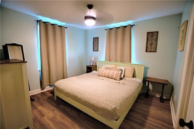 bedroom with dark wood-style floors and baseboards