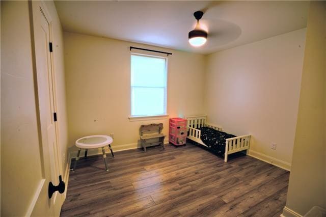 bedroom featuring wood finished floors, baseboards, and ceiling fan