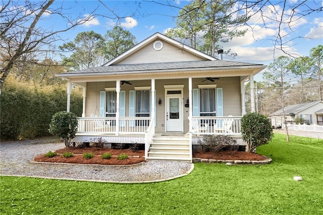 bungalow-style home with ceiling fan, a front lawn, and a porch