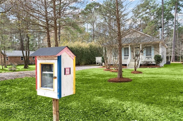 view of yard featuring covered porch