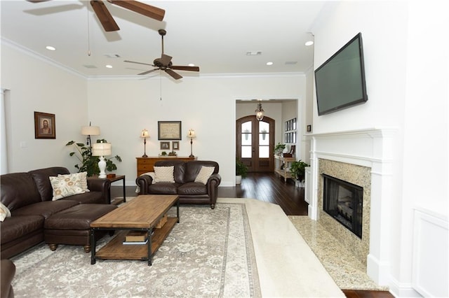 living area featuring french doors, recessed lighting, wood finished floors, and crown molding