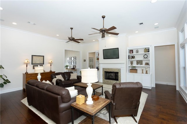 living room featuring visible vents, ornamental molding, dark wood-type flooring, and a high end fireplace