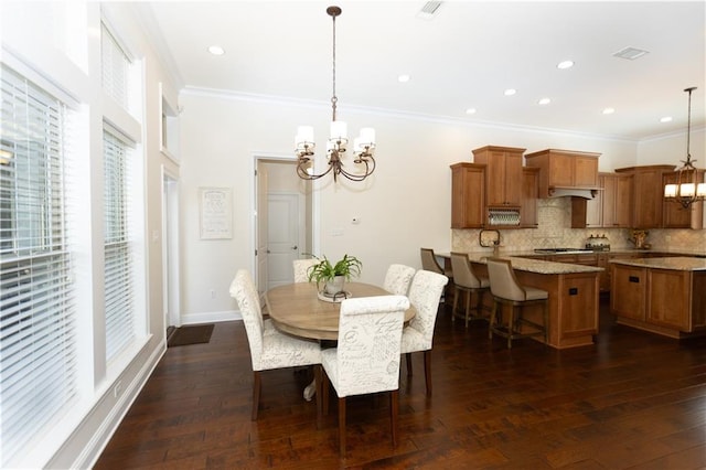 dining room with a chandelier, ornamental molding, dark wood-style floors, and baseboards