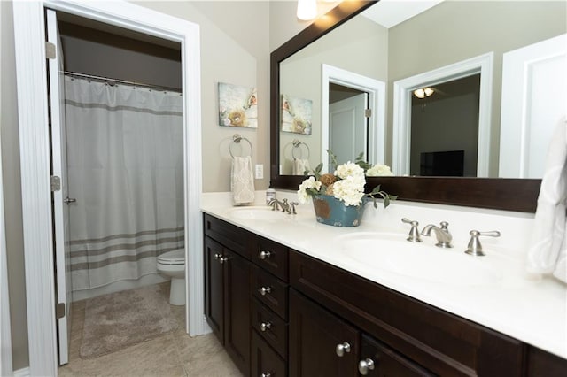 full bath featuring tile patterned flooring, a sink, toilet, and double vanity