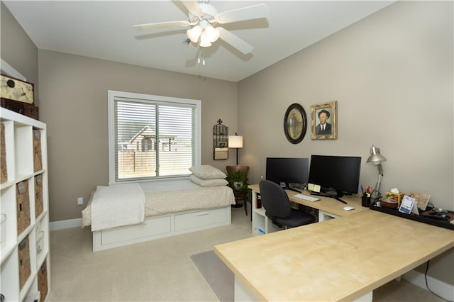 office space with light colored carpet, ceiling fan, and baseboards