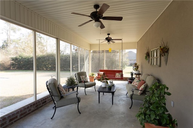 sunroom / solarium with a ceiling fan