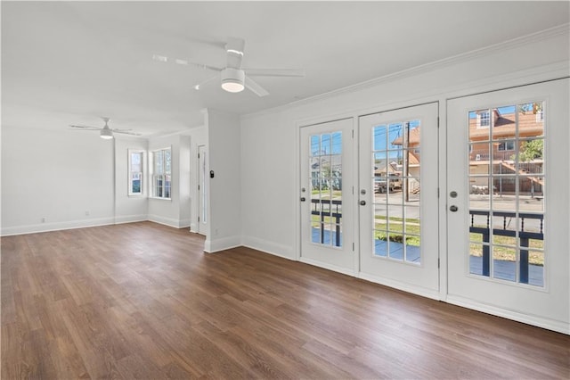 interior space featuring a ceiling fan, dark wood finished floors, and crown molding