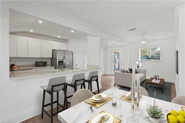 dining space featuring baseboards, dark wood finished floors, a ceiling fan, and recessed lighting
