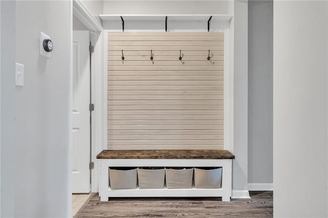 mudroom with wood finished floors and baseboards