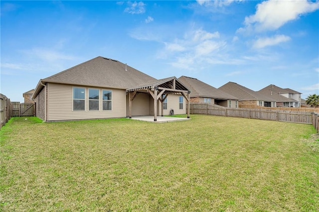 rear view of property with a fenced backyard, a lawn, a gazebo, and a patio