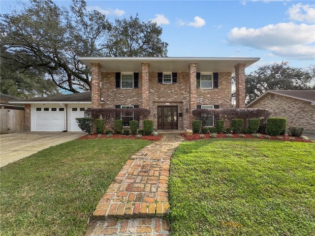 view of front of property with driveway, brick siding, a front lawn, and an attached garage