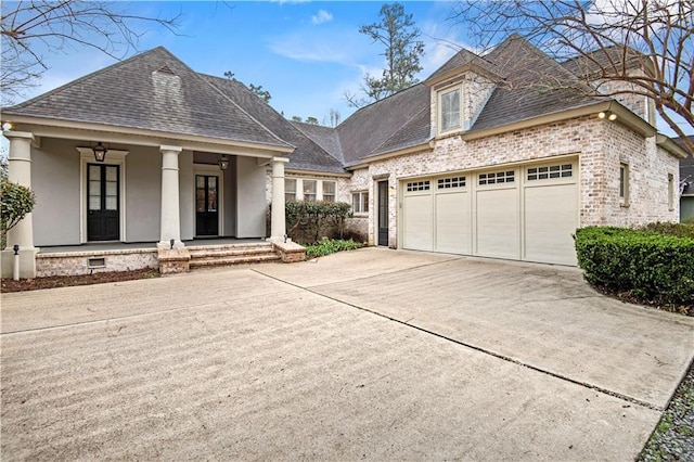 view of front facade featuring a garage, concrete driveway, crawl space, covered porch, and brick siding