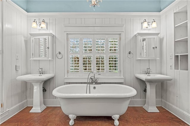 full bath with a freestanding bath and baseboards