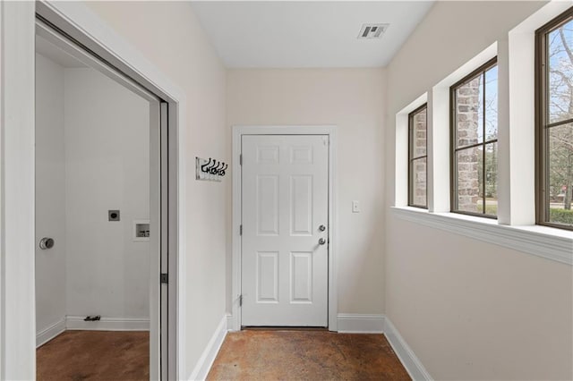 doorway with visible vents, plenty of natural light, and baseboards